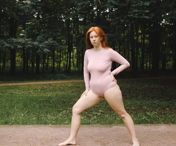 Person meditating outdoors, looking serene and full of vitality.